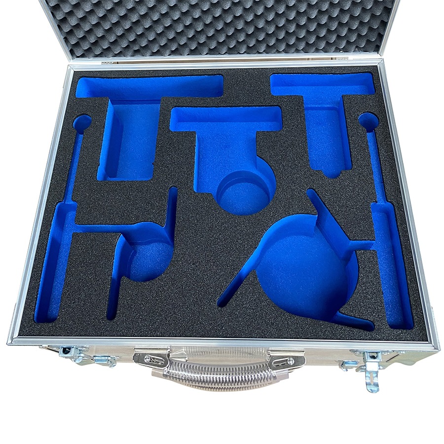 Open aluminum transport case with custom blue foam inserts shaped to hold precision tools or equipment